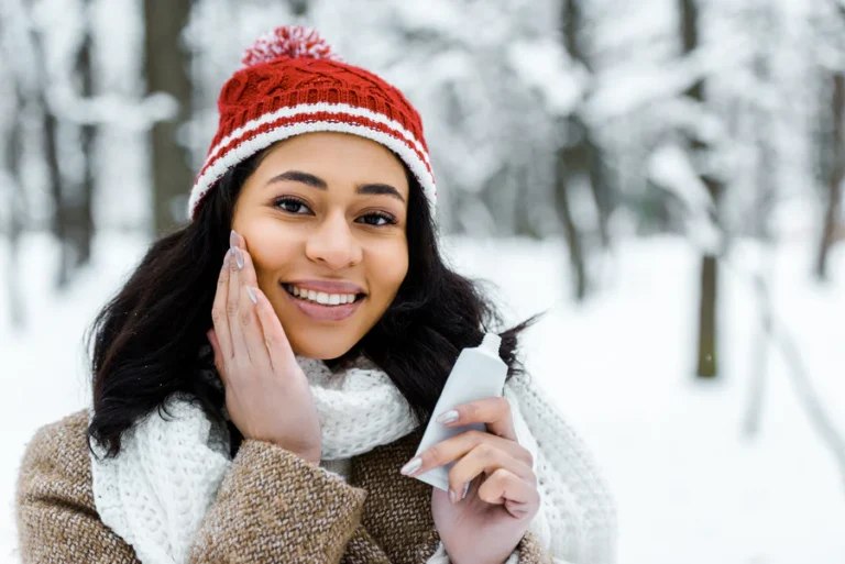 Woman applying her skincare in the winter. Learn all about winter skincare solutions with Aesthetica Medspa in New Jersey.